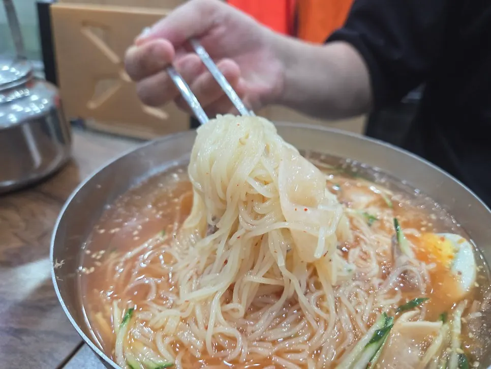 Thin milmyeon noodles lifted with chopsticks