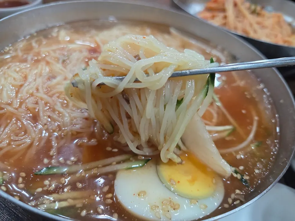 Spooning up mul-milmyeon broth
