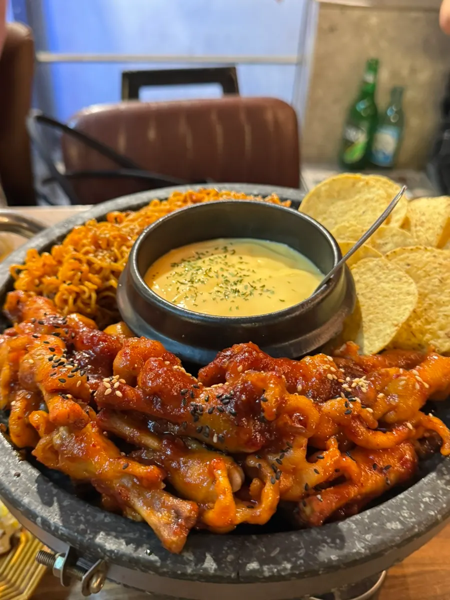 Full view of the fondue chicken feet on the stone plate