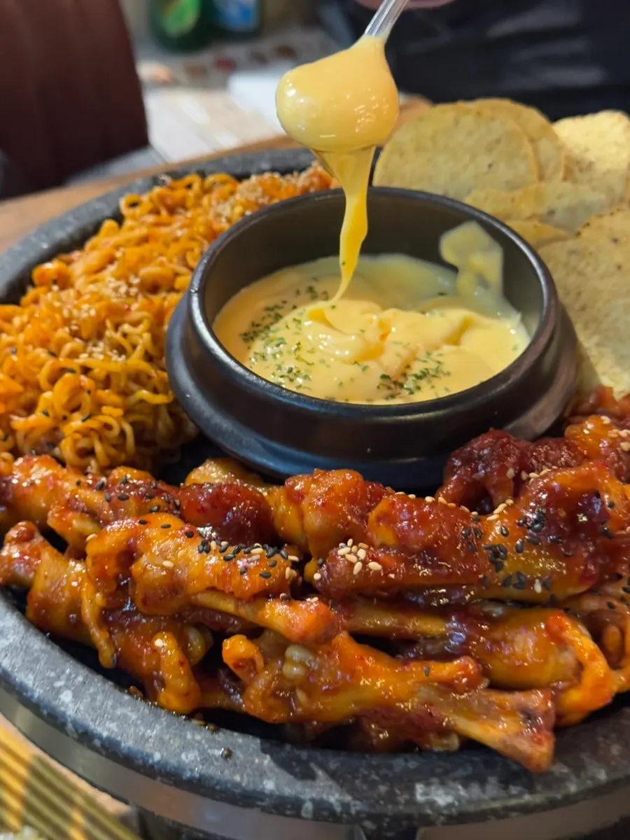 Chicken feet bubbling on the stone plate
