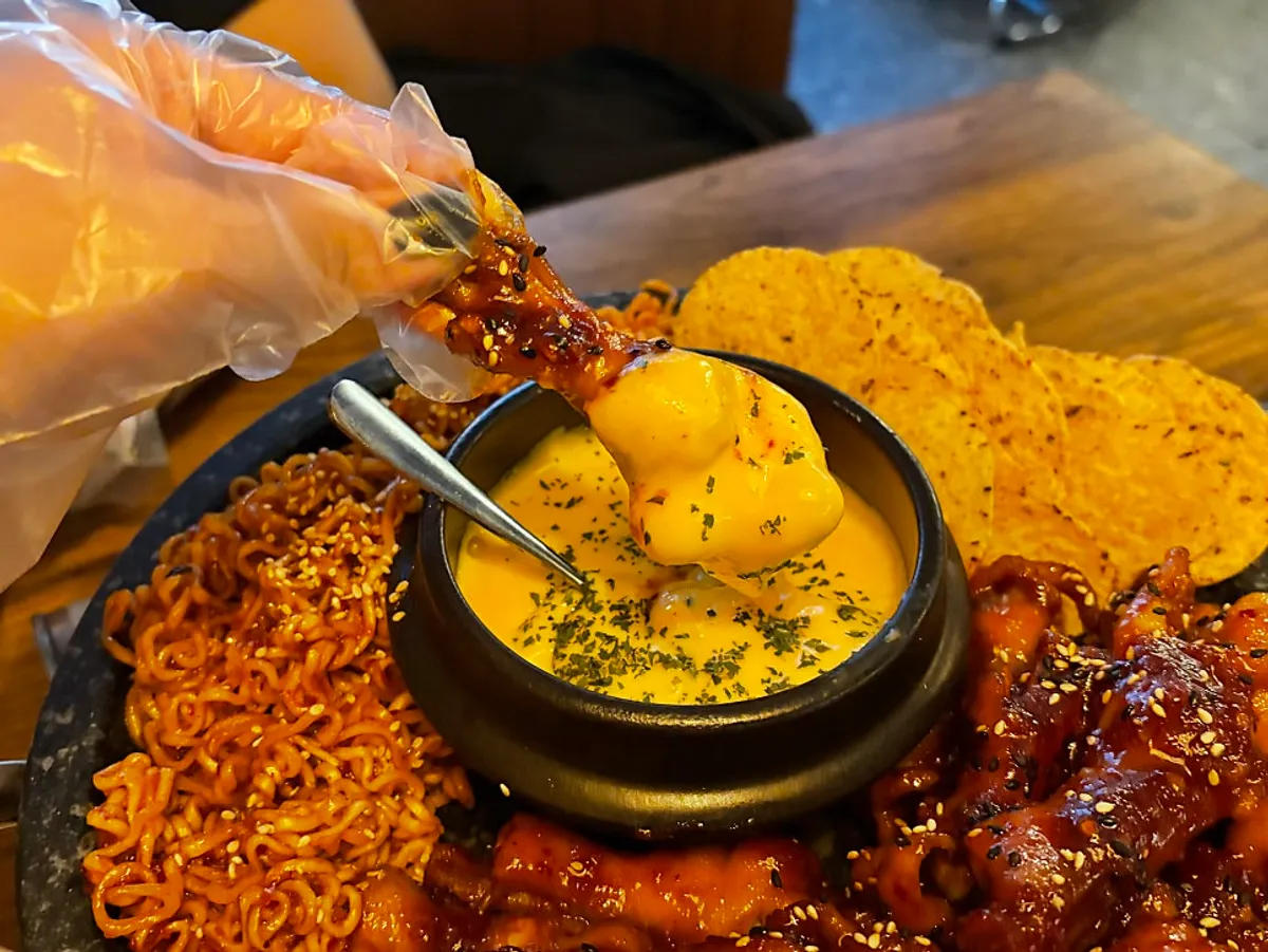 A full stone-plate spread of fondue in chicken feet at Mokhwa Silbi