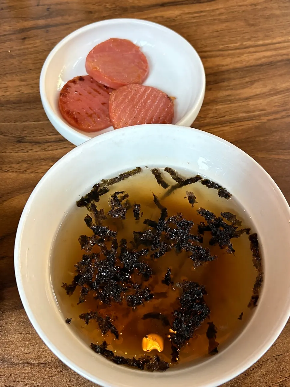 Mukguksu and pink sausage side dishes