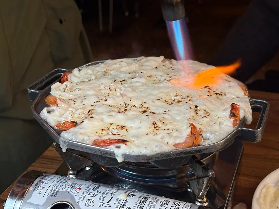 Torching the cheese to melt it