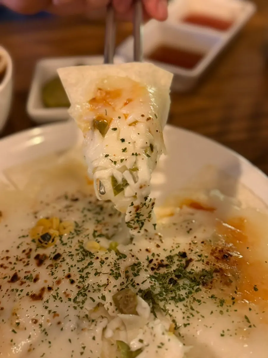 Shrimp and cream cheese piled on the tortilla pizza