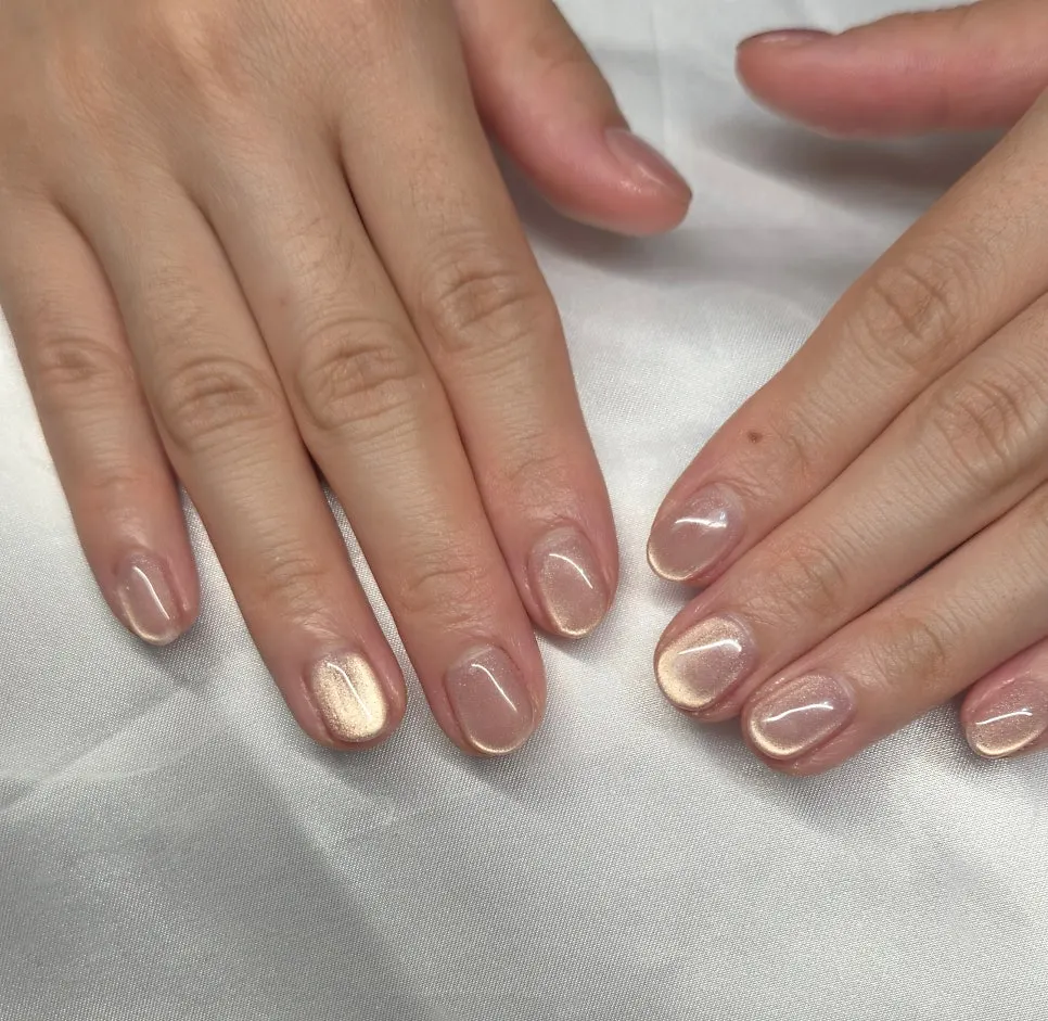 Magnetic gel nails appearing pink or white depending on the light