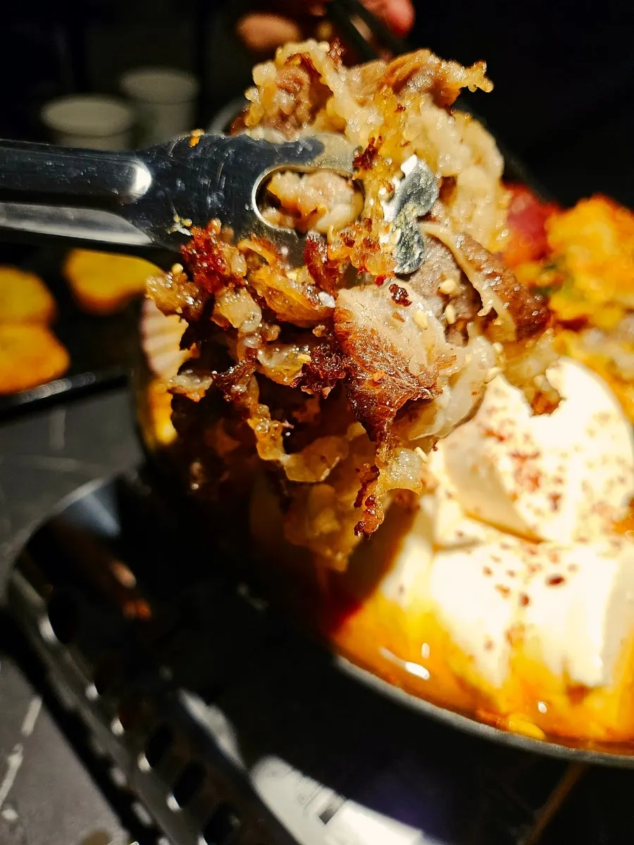 Seafood hot pot filled with soft tofu and beef belly