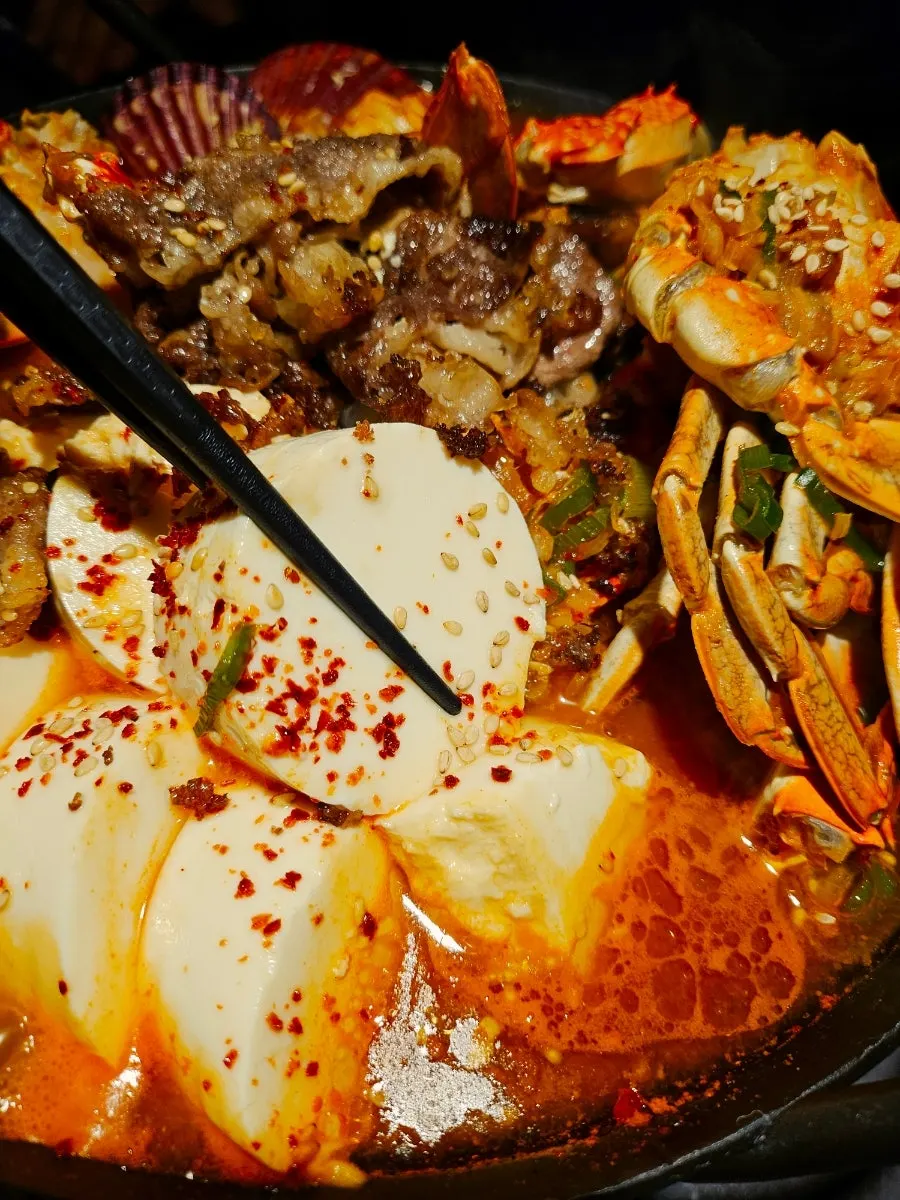 Beef belly and soft tofu scooped out of the hot pot