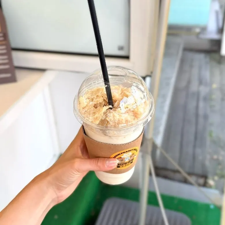 Holding a peanut latte from Daeshin Peanut Bread