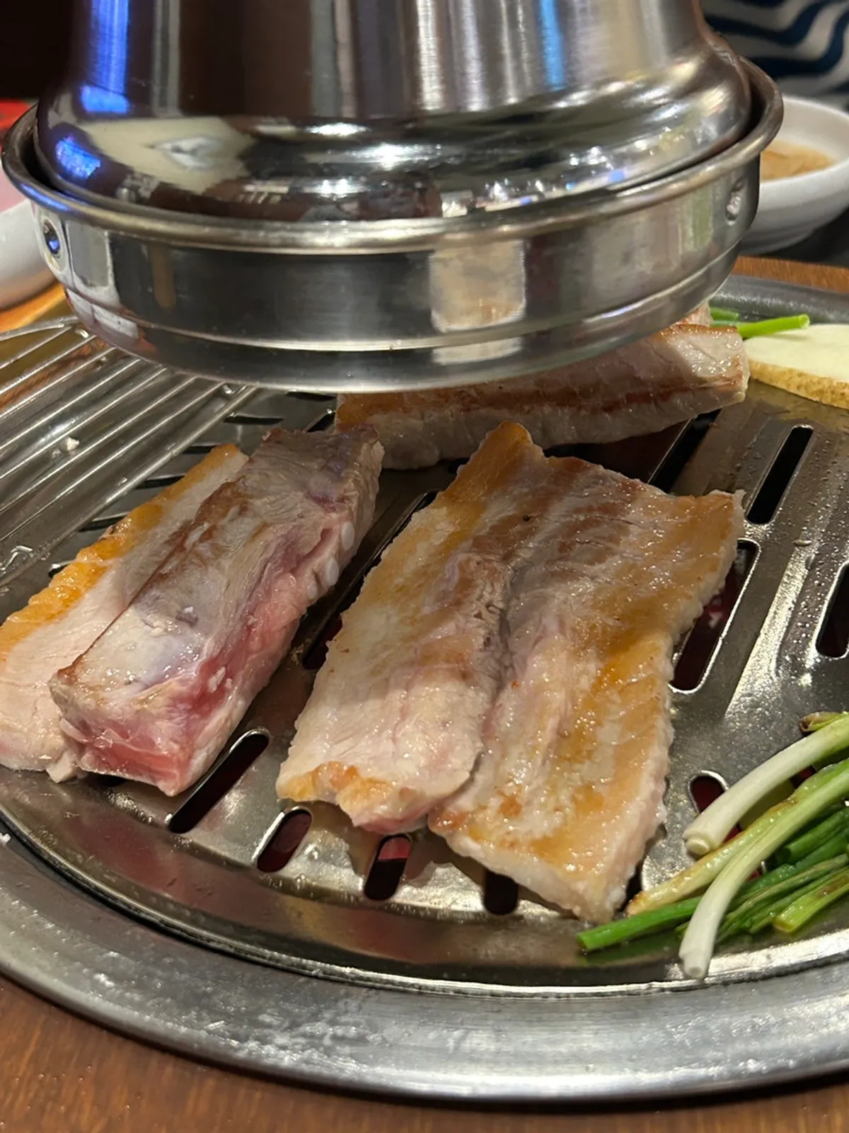 Fresh pork ribs with charcoal, potatoes, and scallions