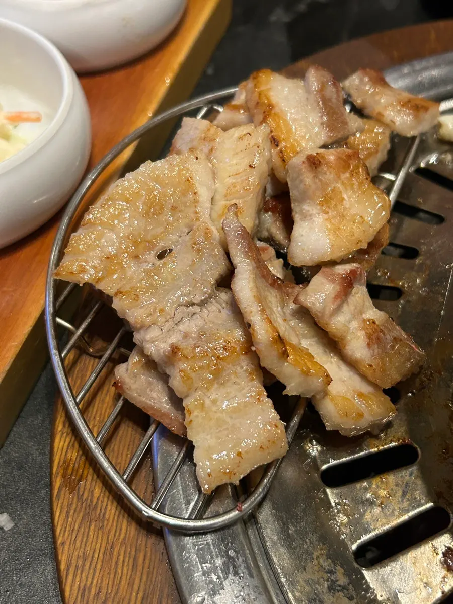 Fresh pork ribs grilling over charcoal