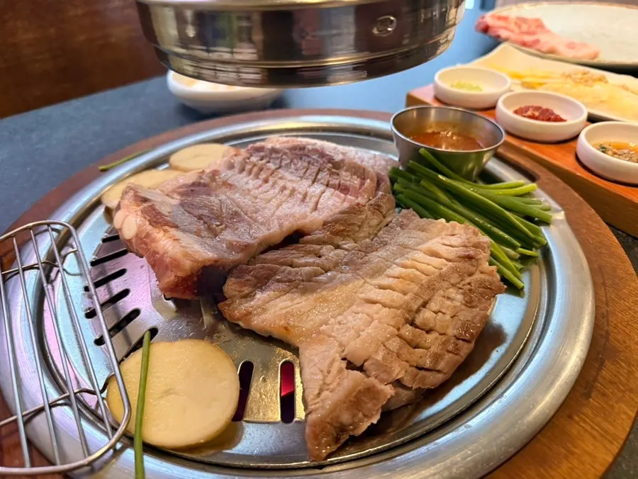 Close-up of pork ribs grilling over charcoal