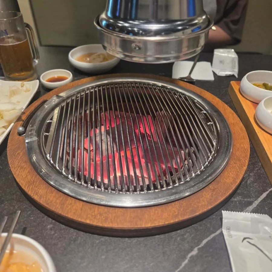 Marinated pork ribs placed on the charcoal grill plate