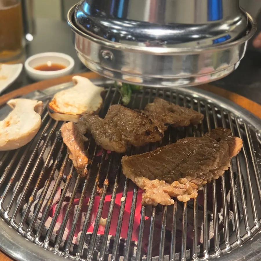 Close-up of marinated ribs grilling over charcoal