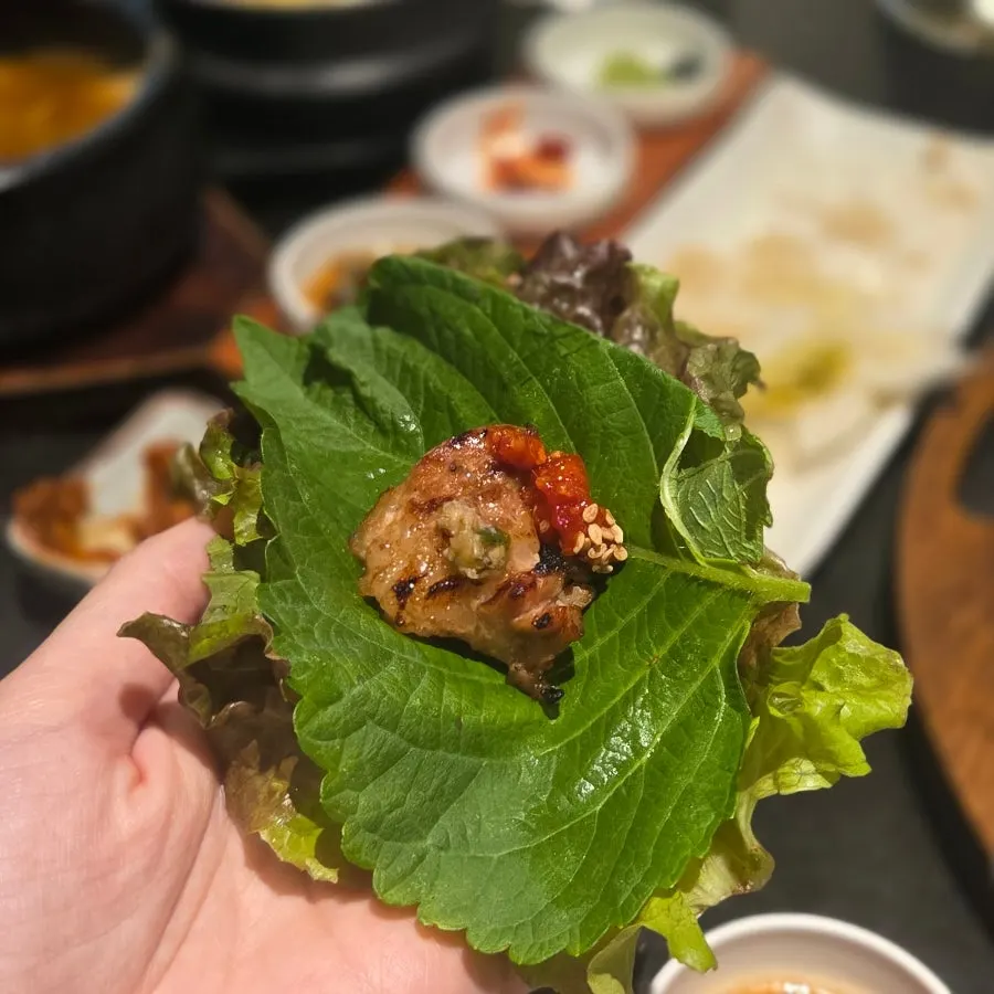 A piece of marinated rib placed on a lettuce leaf