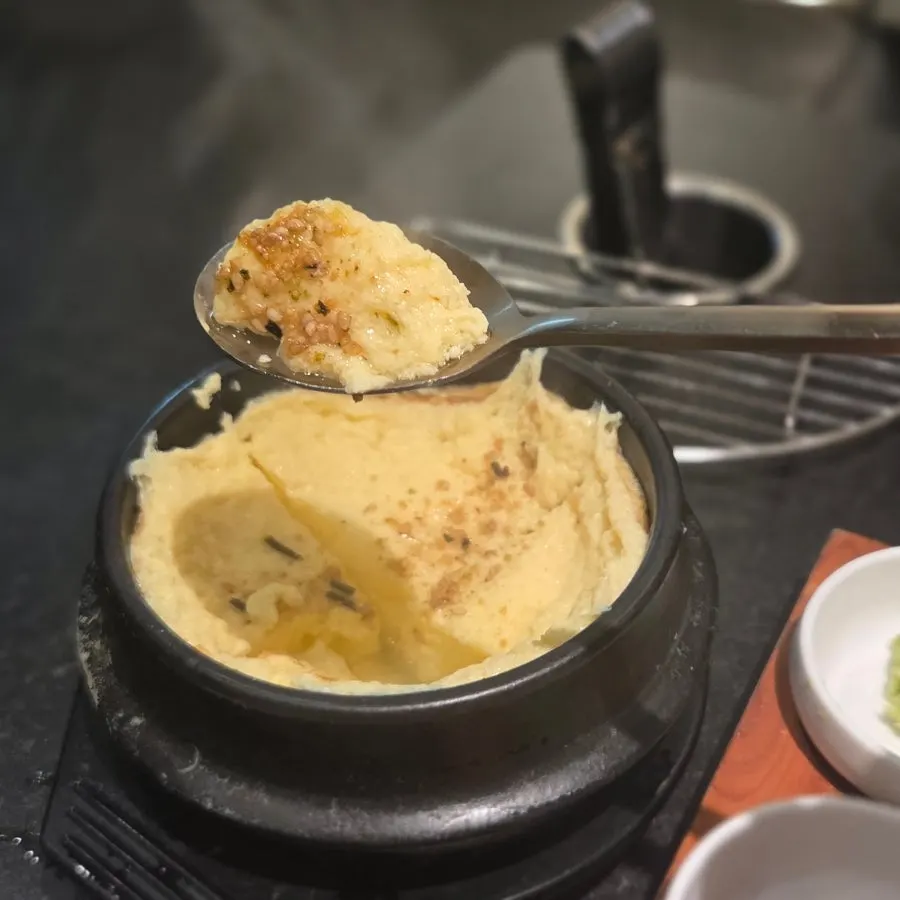 A spoonful of steamed egg scooped up