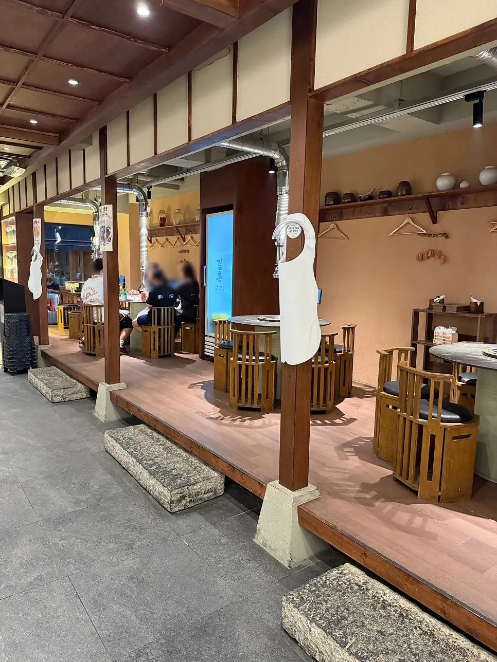 Korean-tavern-style seating on the sides of the restaurant