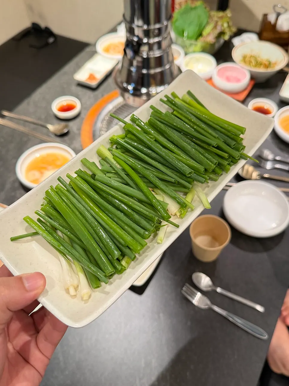 Side dish plates set beside the grill