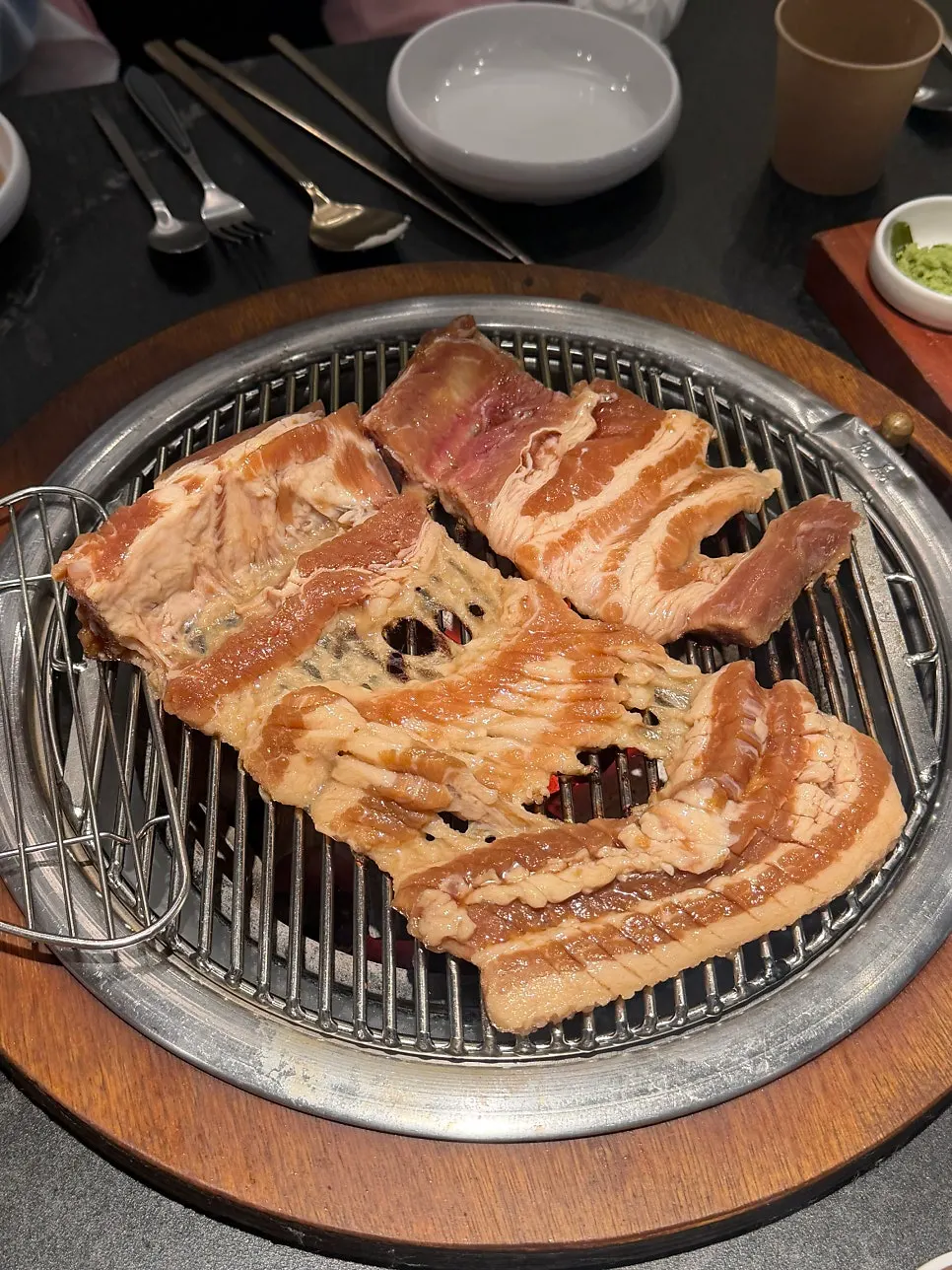 Marinated pork ribs grilling on the grate