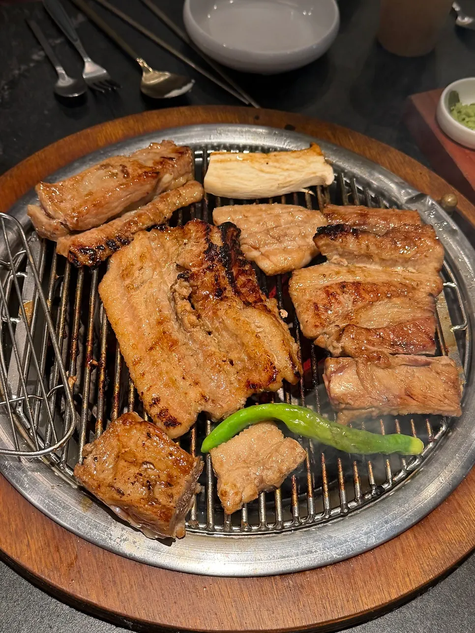 Marinated ribs being flipped repeatedly while grilling
