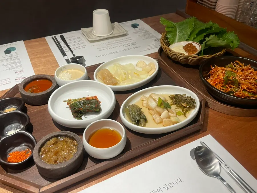 Pork belly served with sauces and vegetables