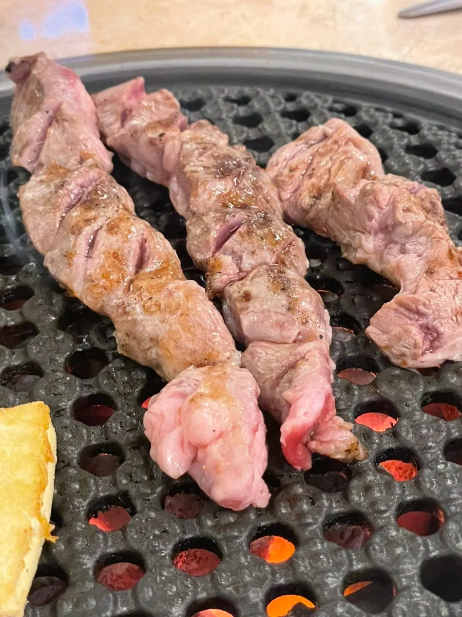 1-hour Saturday wait for skewered gamjagisal BBQ in Seomyeon, Busan