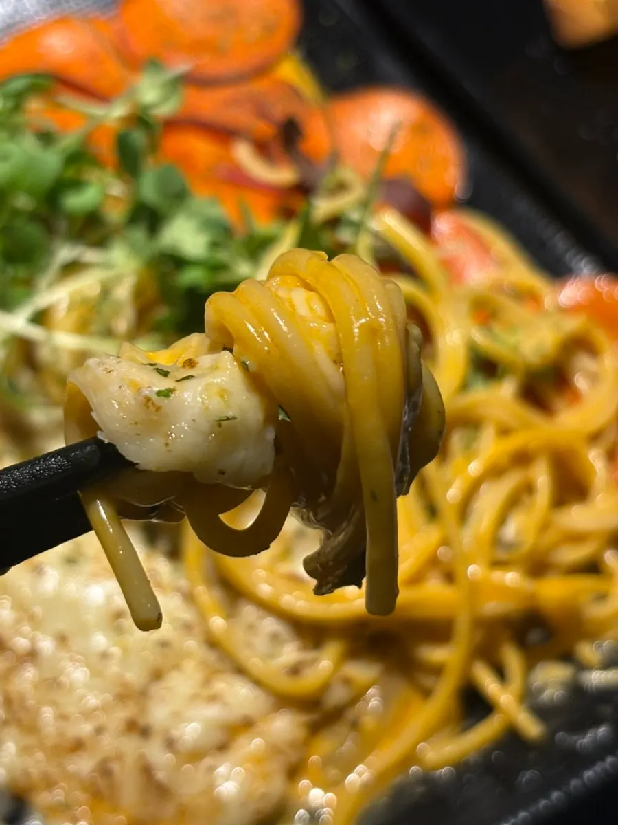 A stretchy cheese-covered bite of the potato pancake