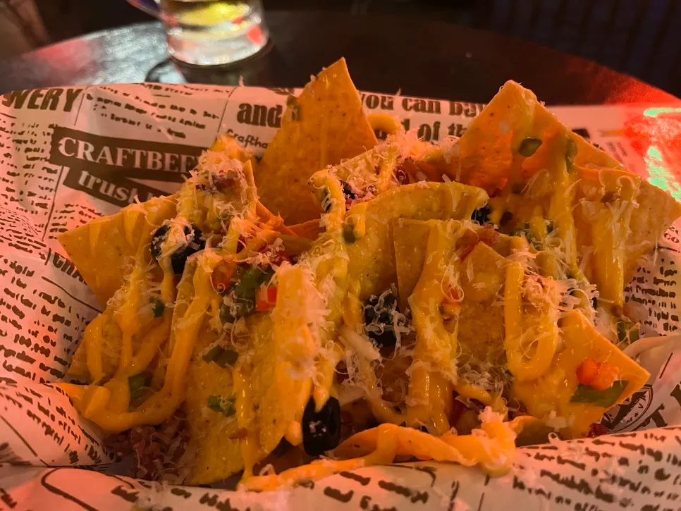 Picking up a crispy piece of cheese nachos