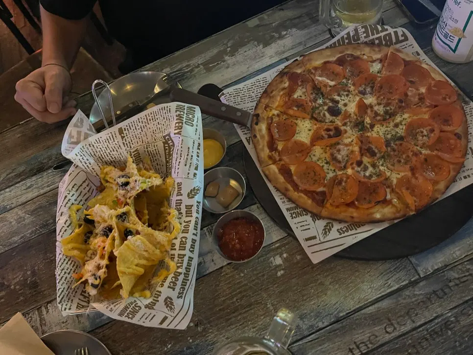 Pepperoni pizza served with beer