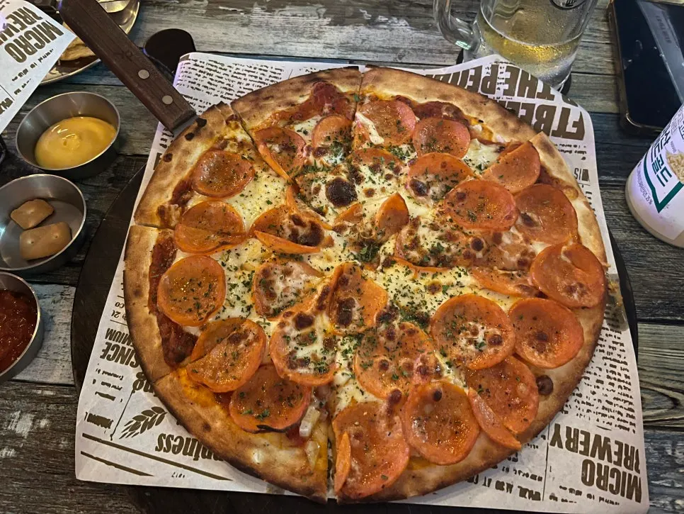 Surface of the pizza topped with pepperoni and cheese