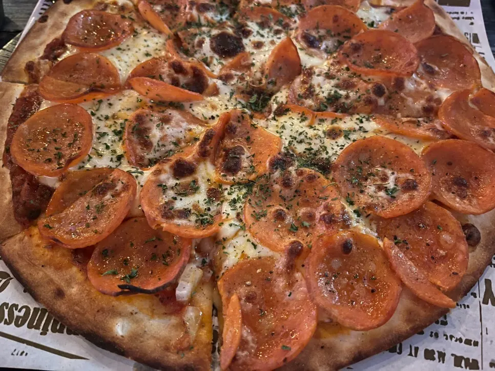 Pepperoni pizza and cheese nachos set out together