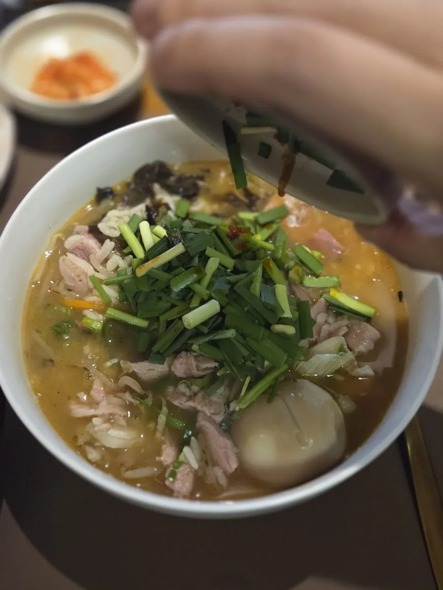 Broth and ingredients in the miso pork gukbap