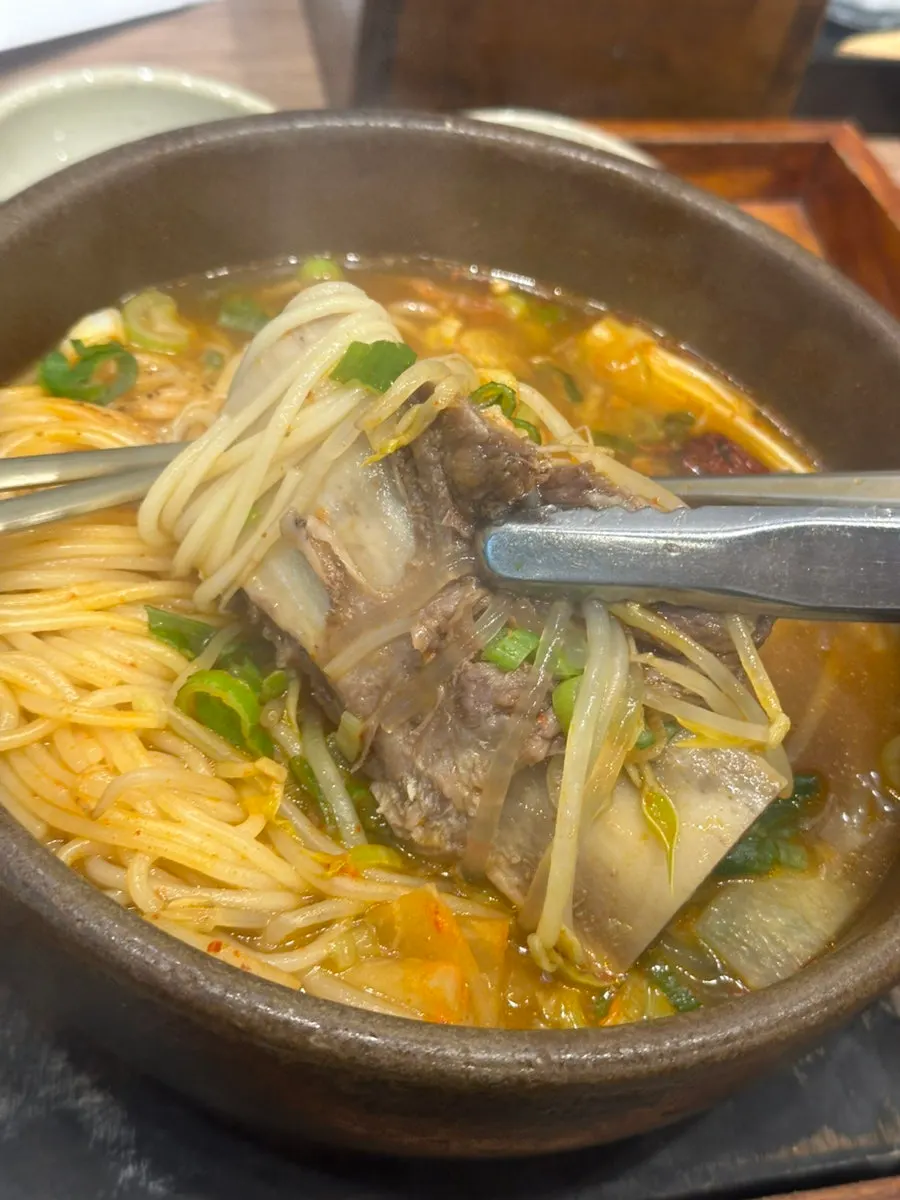 Inside the galbitang with mushrooms, scallions, and noodles