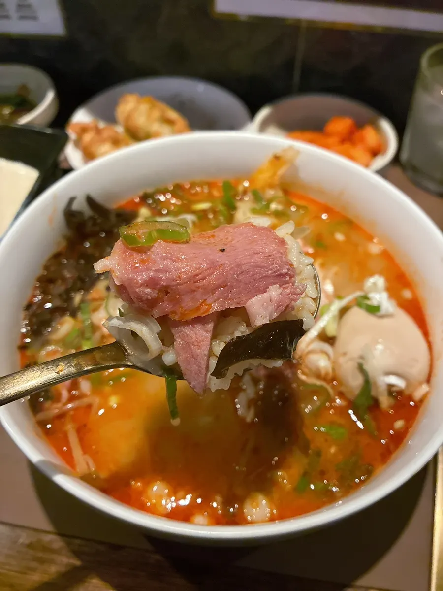 Spicy pork gukbap with rice in a spicy broth