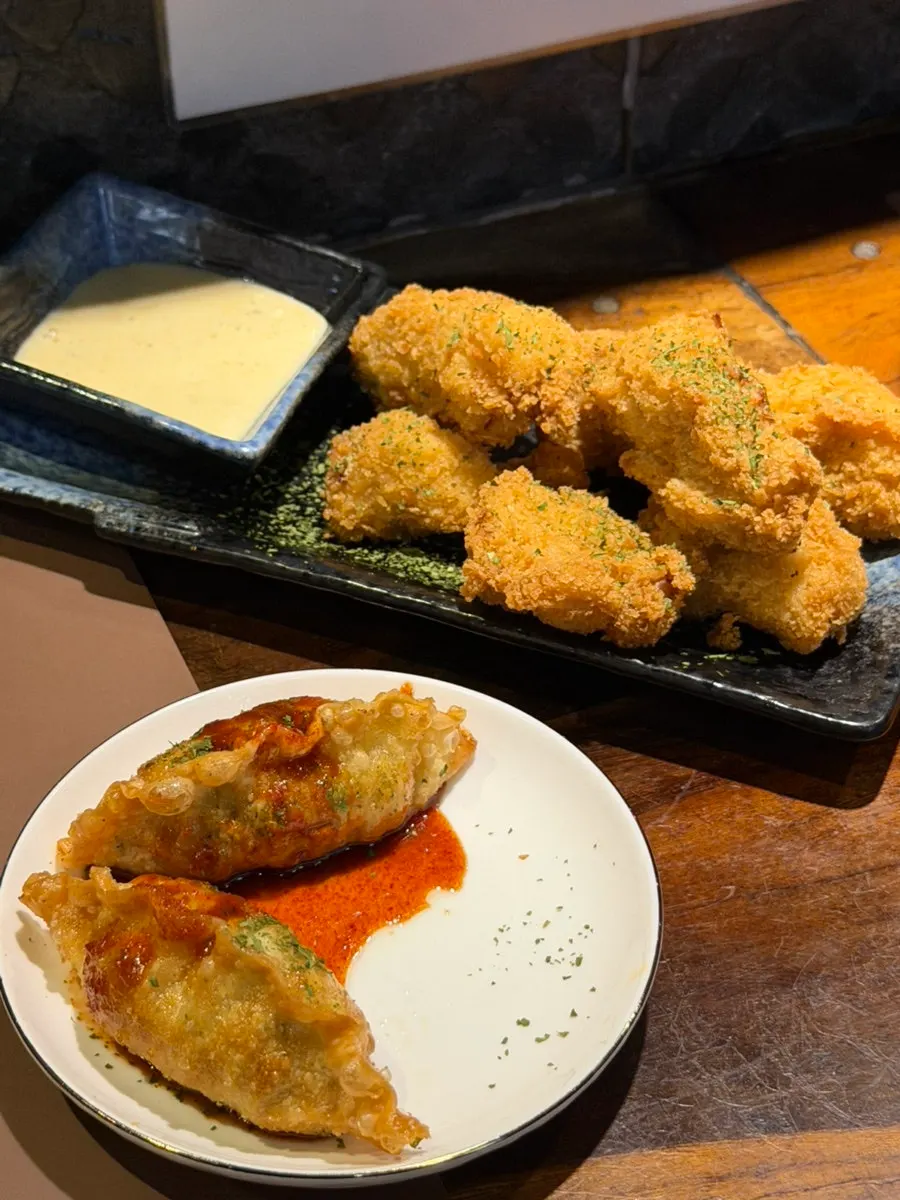 Full table with gukbap, small fried chicken, and wang-gyoja