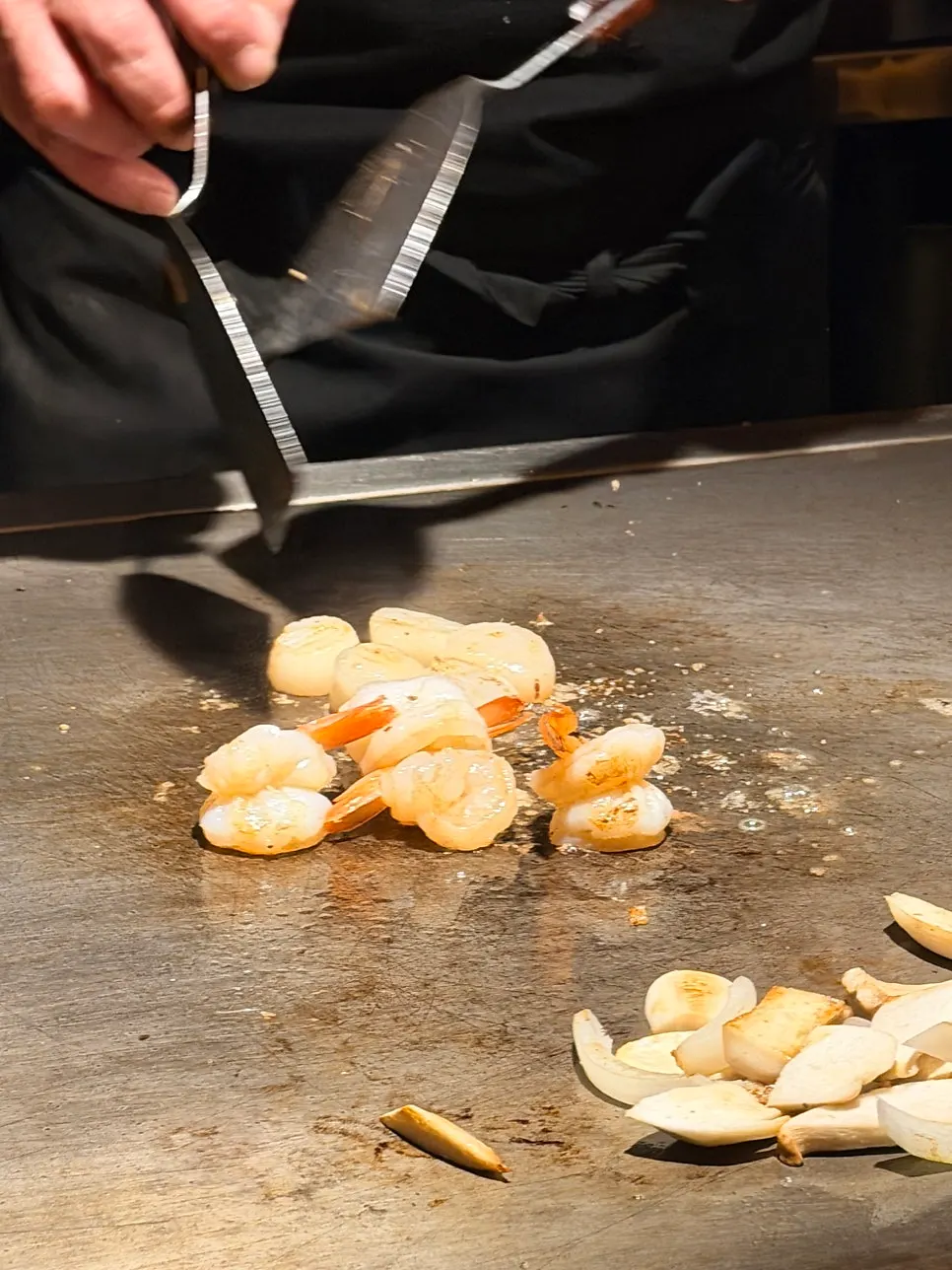 Teppanyaki dishes being cooked quickly
