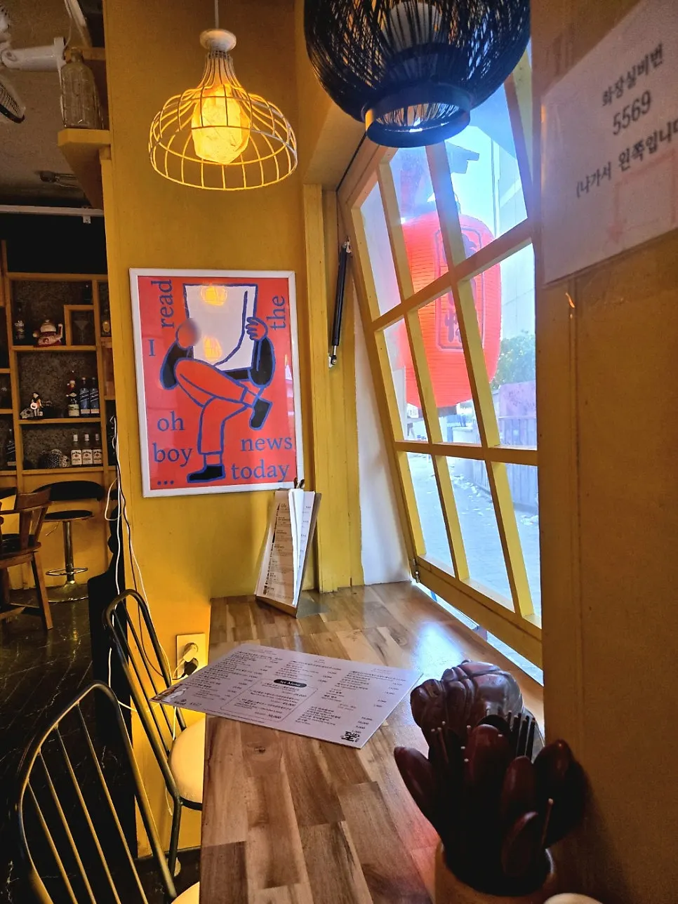 Inside Teppan King with liquor bottles on yellow shelves
