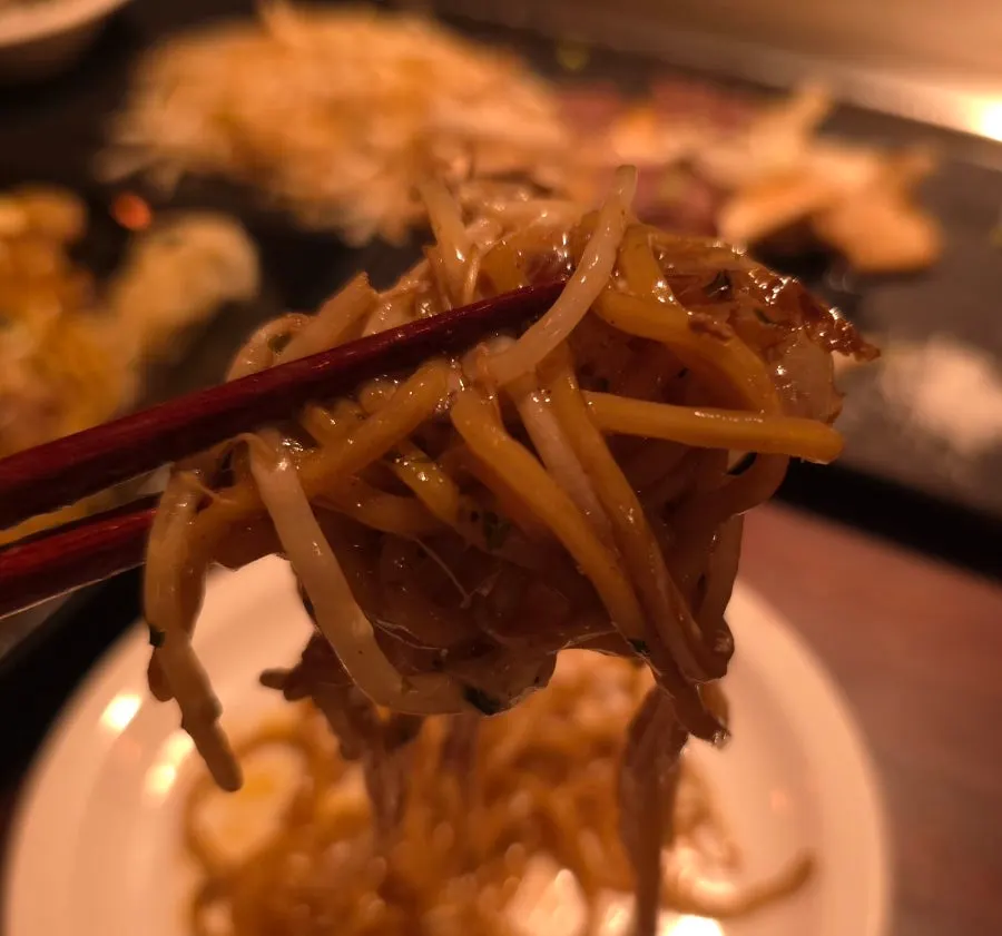 Yakisoba topped with a runny fried egg