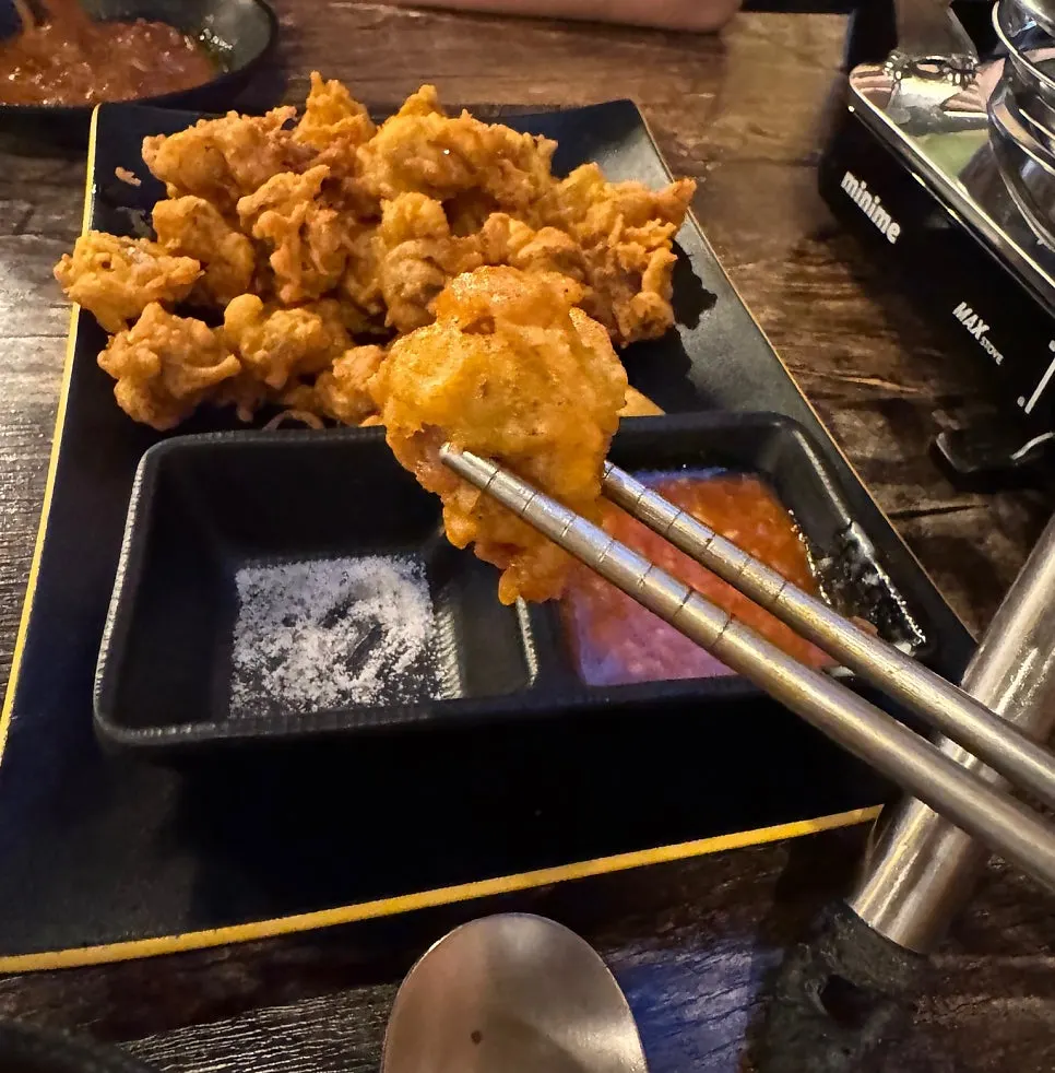 Fried chicken gizzard dipped into the dakdoritang broth