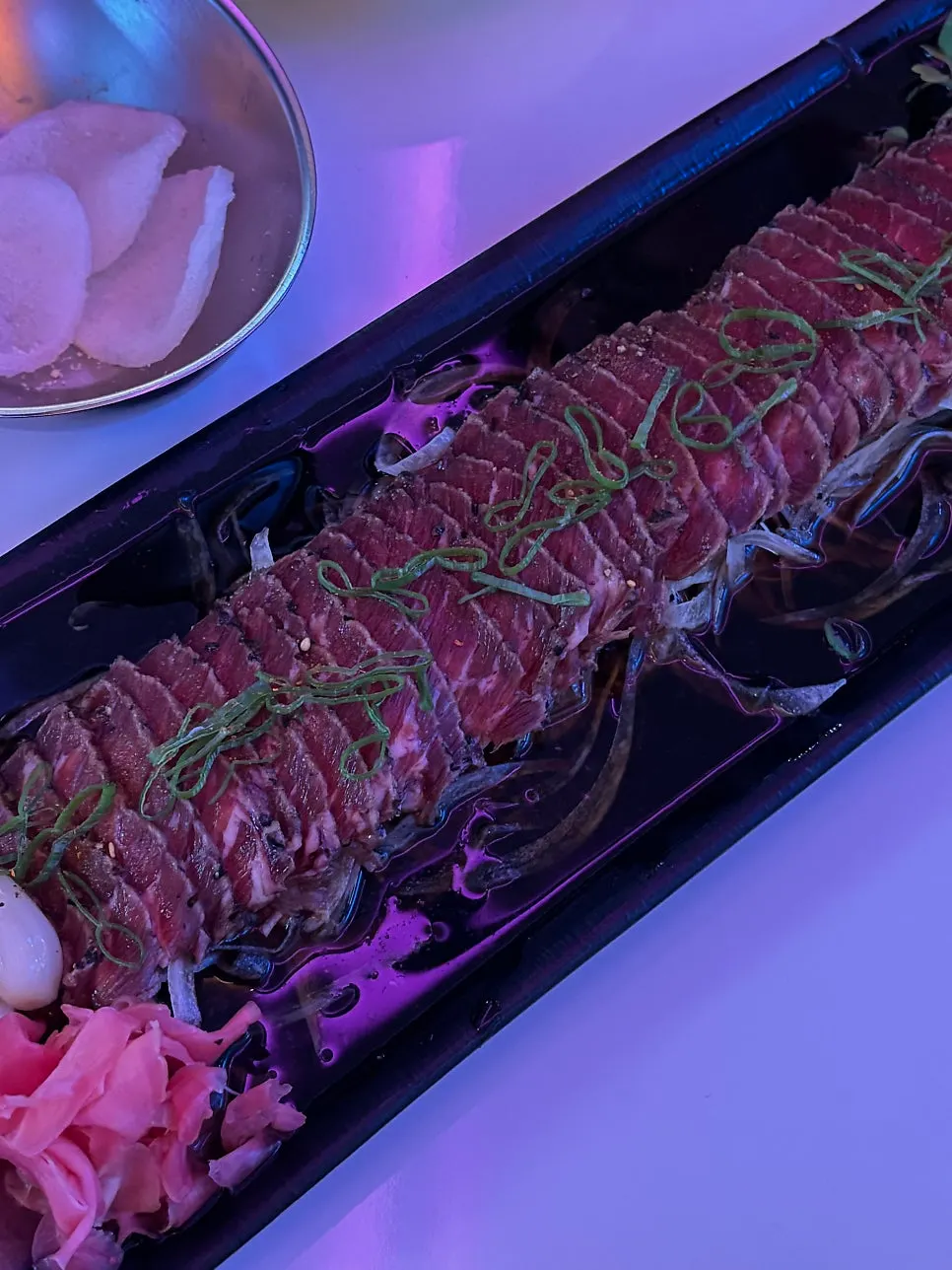 Close-up of beef tataki drizzled with sauce