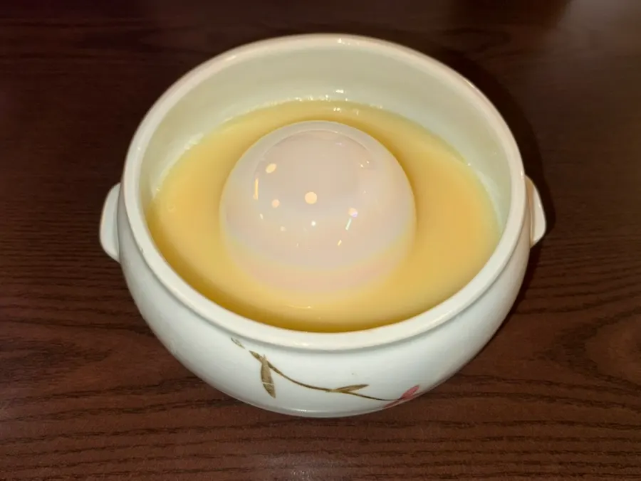 Yuzu makgeolli glass with a pearl floating in it