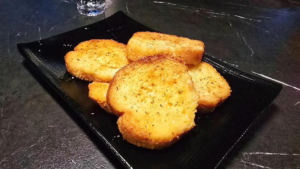Sweet garlic bread served as the house anju
