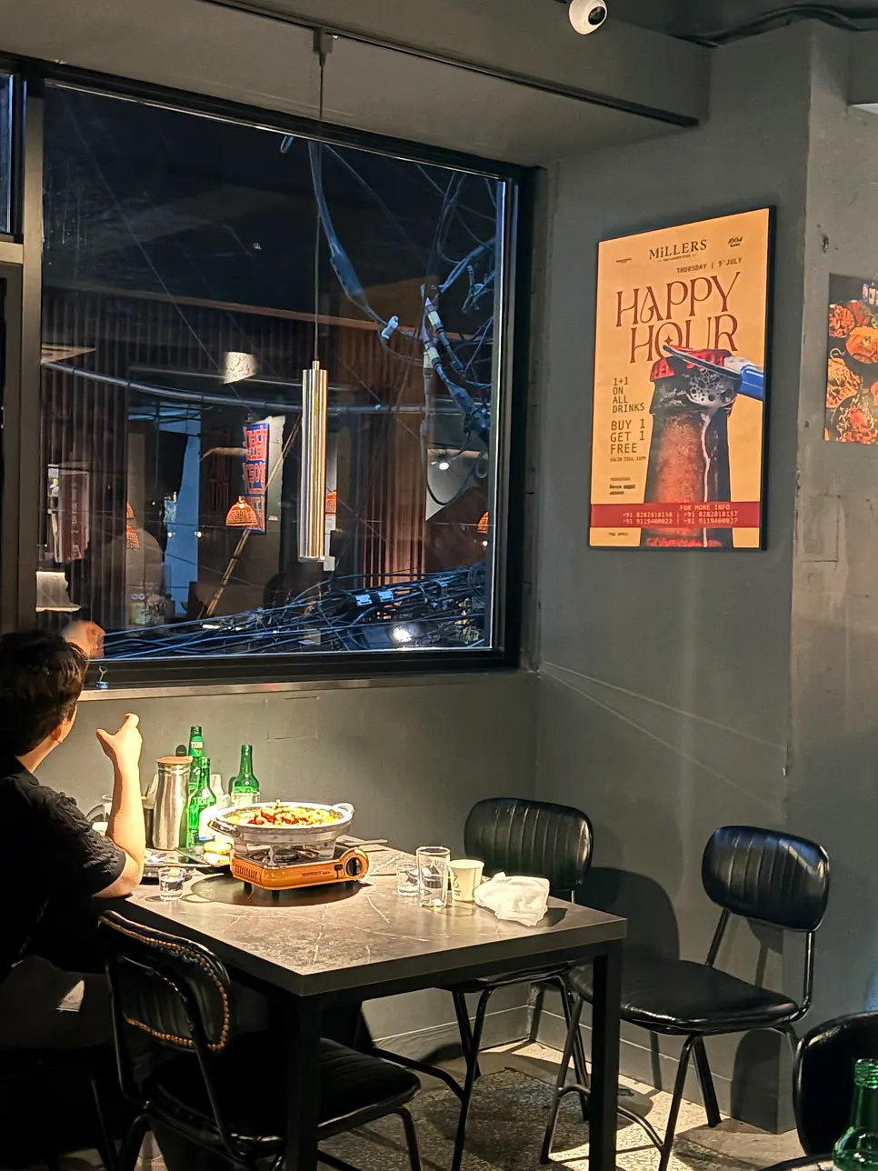 Wall decorated with posters and framed art