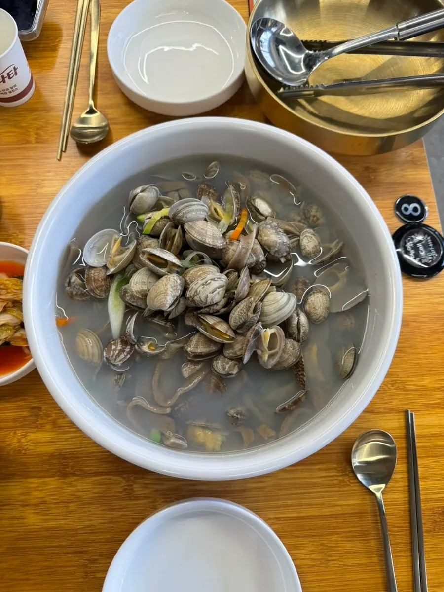 Table spread with buckwheat clam kalguksu for two and king dumplings