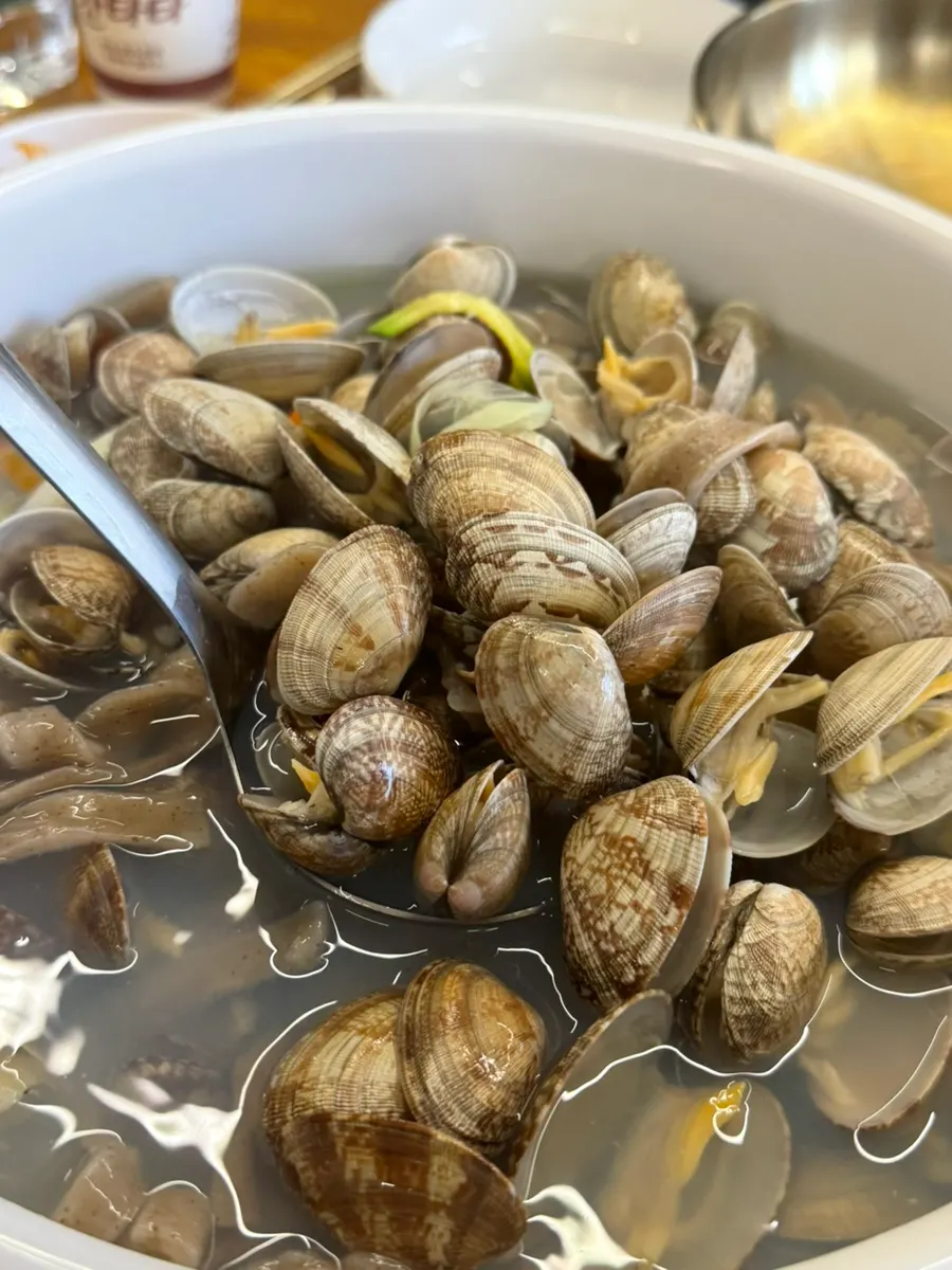 Pot of kalguksu piled high with clams