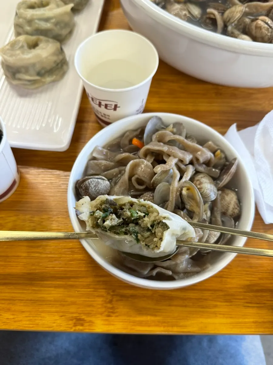 Buckwheat noodles lifted out of the broth