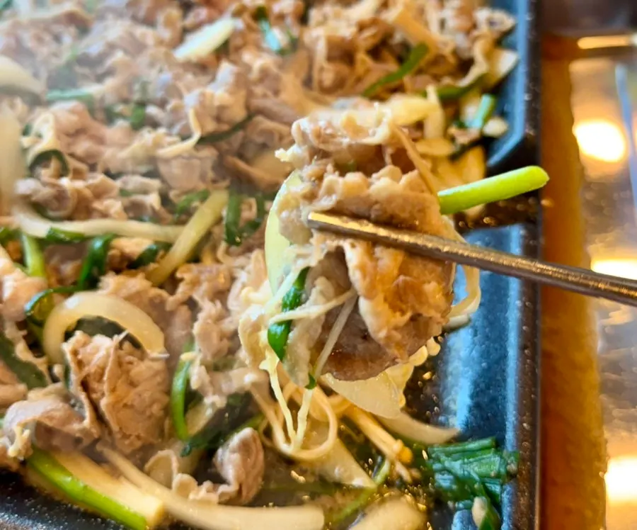 Soy sauce duck bulgogi sizzling on the grill