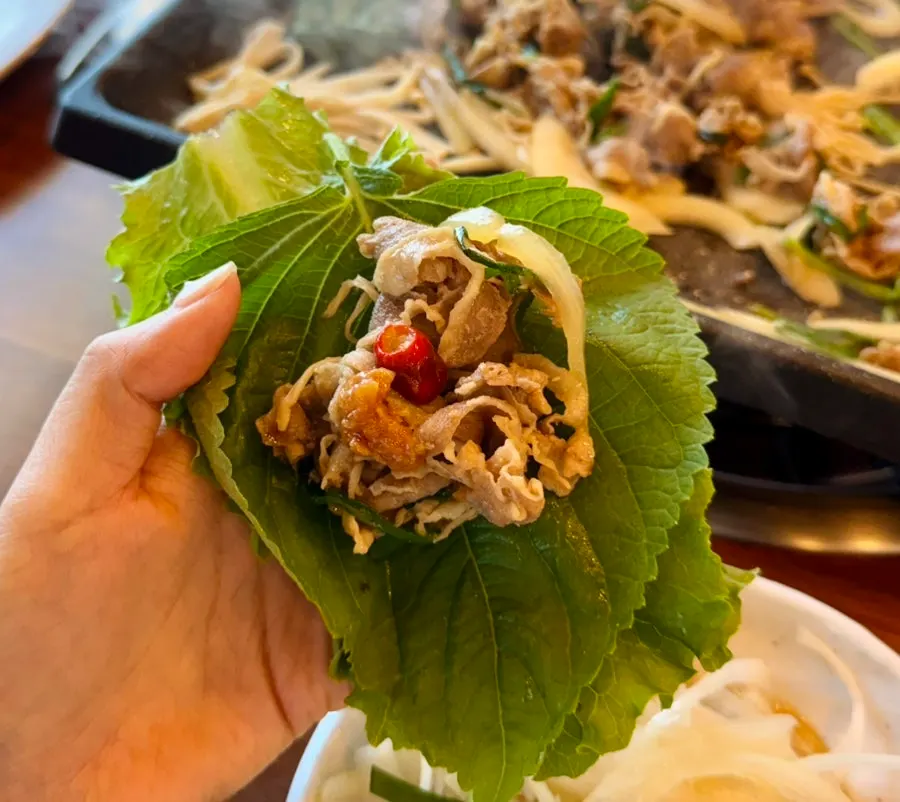 Duck meat wrapped in lettuce and perilla leaf