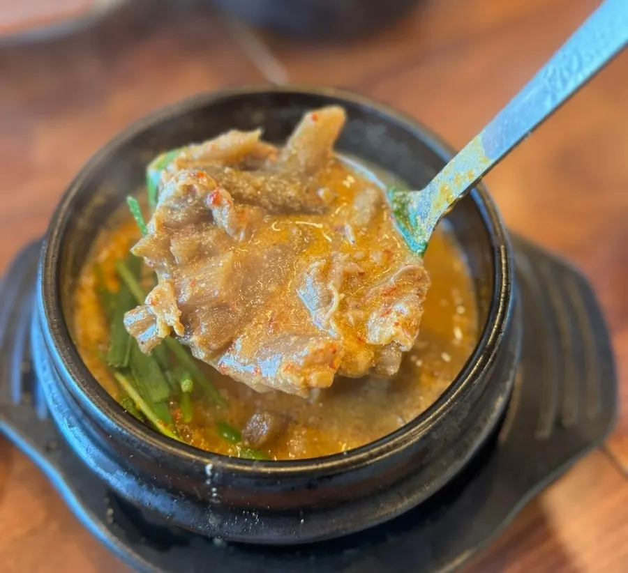Rich duck soup broth loaded with ground perilla seeds