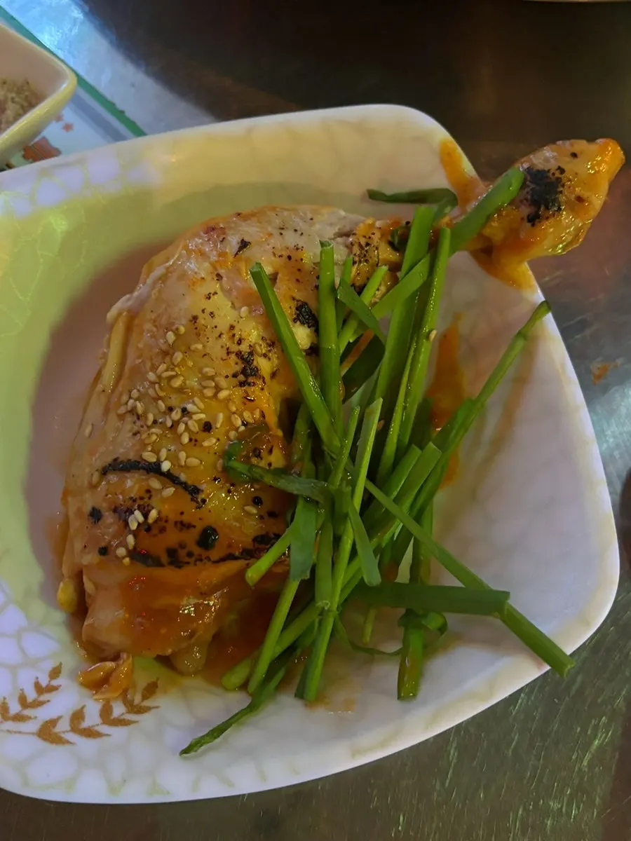Close-up of the large sauced chicken leg
