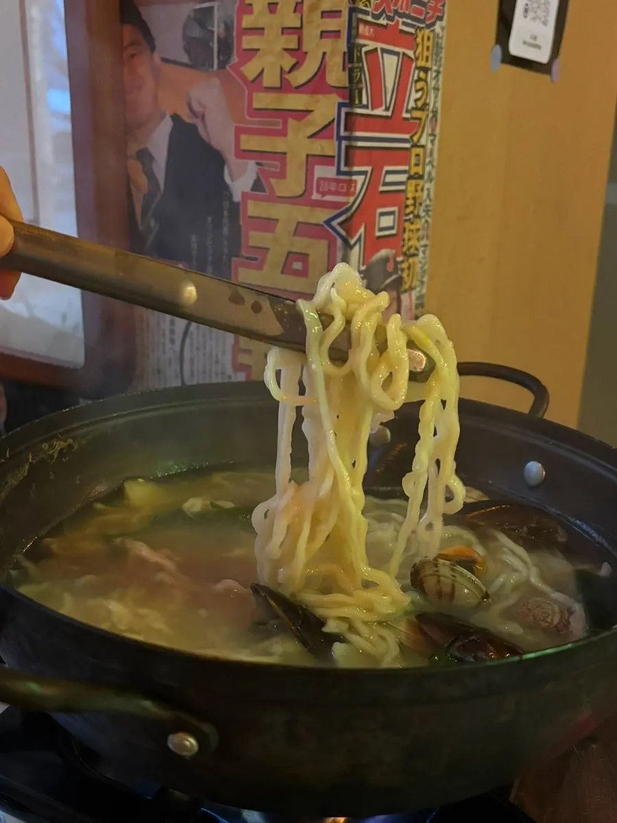 Chewy noodles lifted from the seafood kalguksu